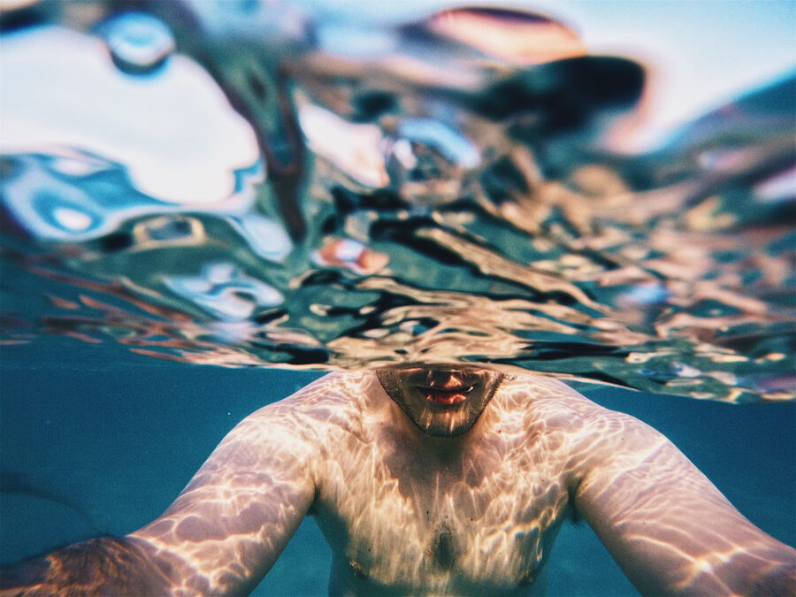 A face at the surface, half above the water and half below